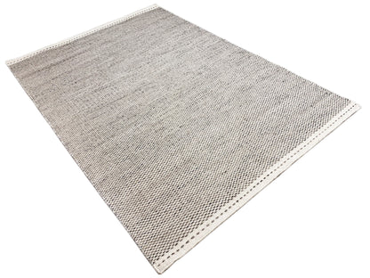 Silver kilim rug, diagonal view, woven checkered pattern, bound edges