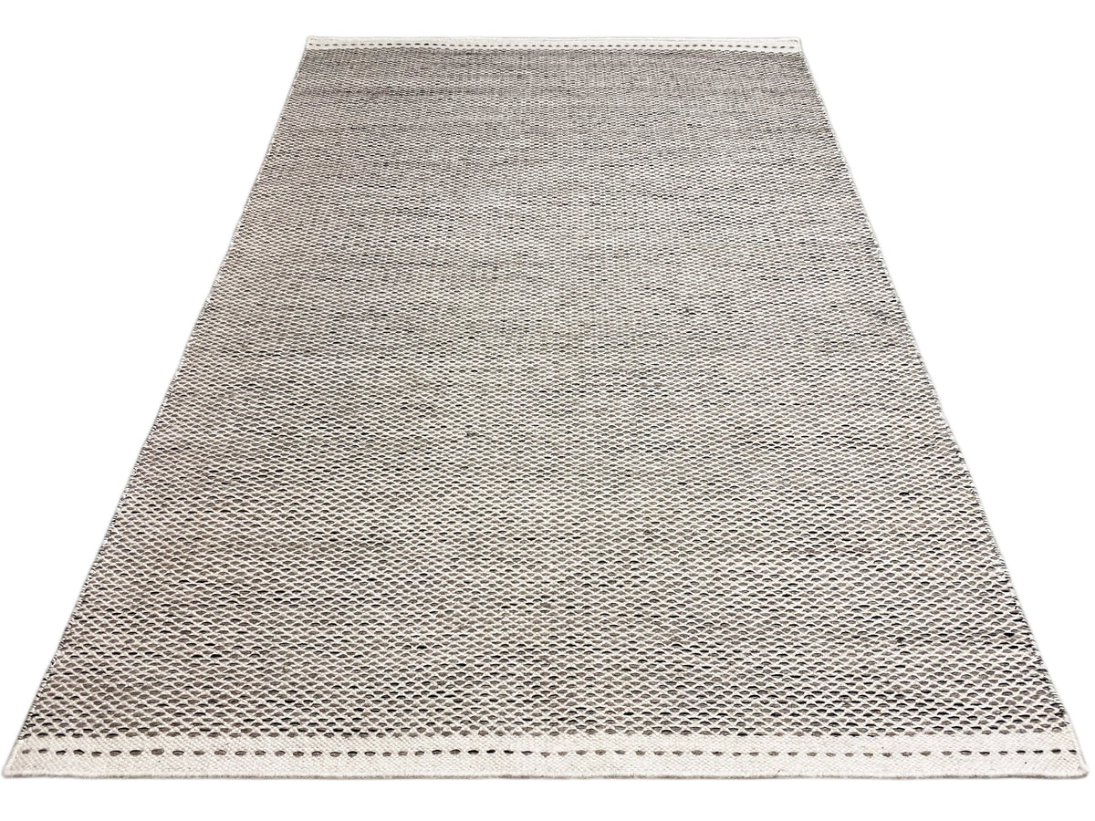 Kilim rug in silver, spread out over a large area, fine linear woven pattern, edge stitching