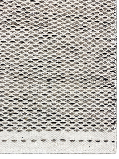 Kelim rug in silver with a relief weave texture, close-up, dotted decorative border