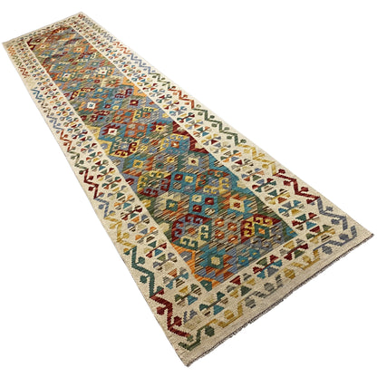 Kelim runner, longitudinal view, with colorful diamond and decorative motifs on a light background