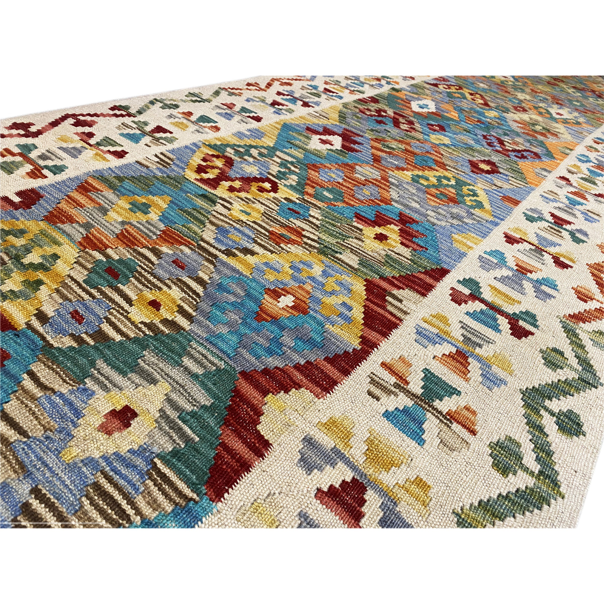 Detailed view of the kilim runner: densely woven texture with colorful small patterned sections
