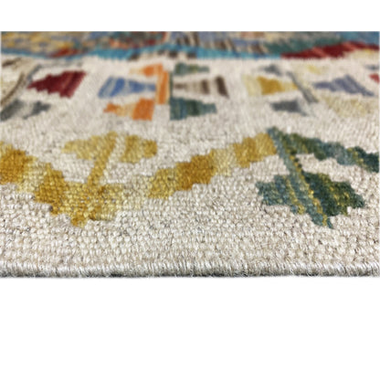 Detail of the kilim runner: pile/weave visible, colorful motifs in blue and ochre