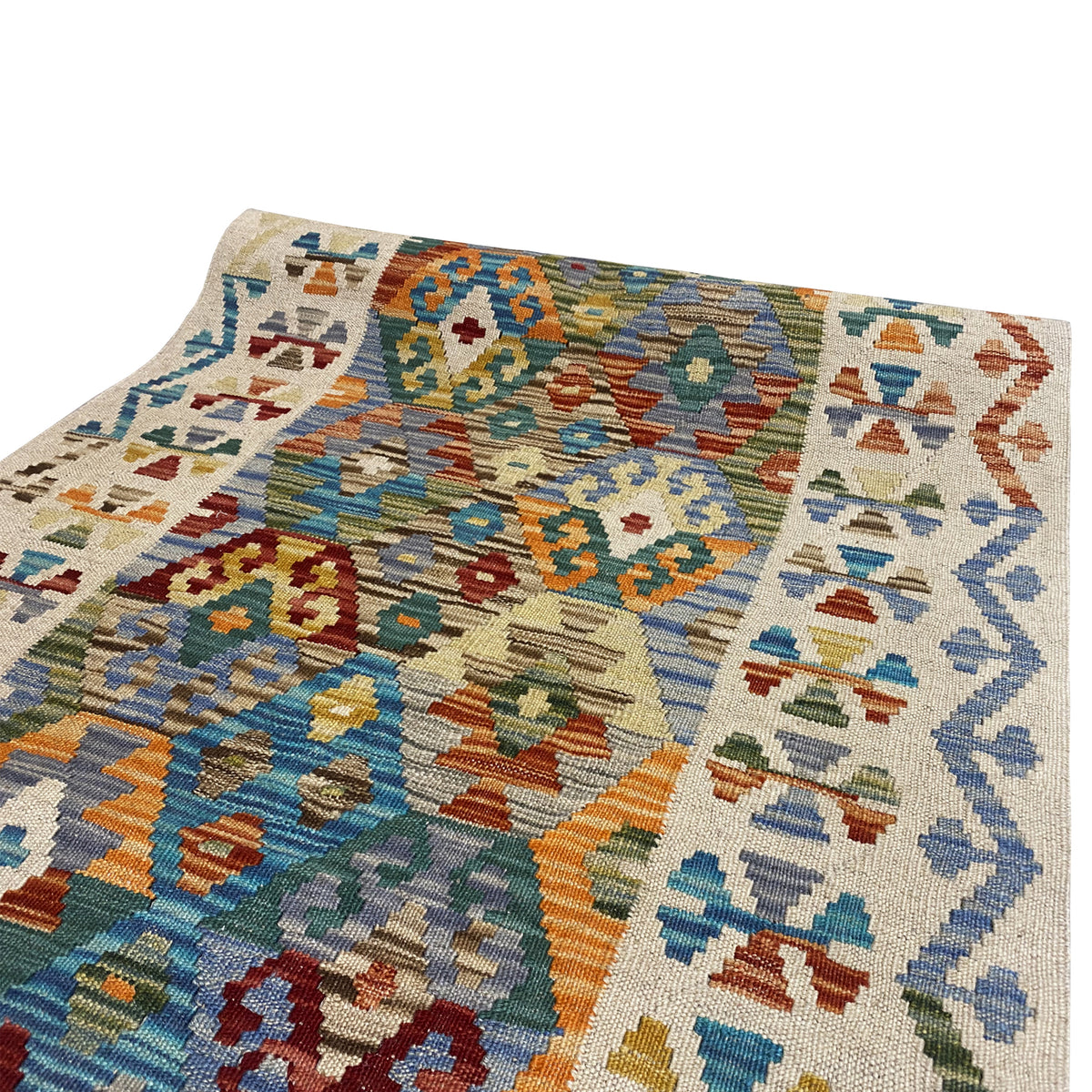 Woven detail: kilim runner with patchwork-like ornaments in blue, green, and orange