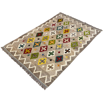 Kilim rug with square cross and diamond motifs on a gray background, zigzag edge