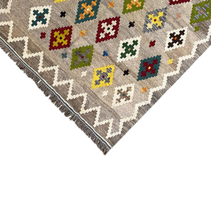 Kelim rug edge with zigzag border, colorful diamonds/crosses, and fringes