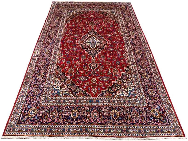 Red carpet with central medallion and multicolored border; even edge finish