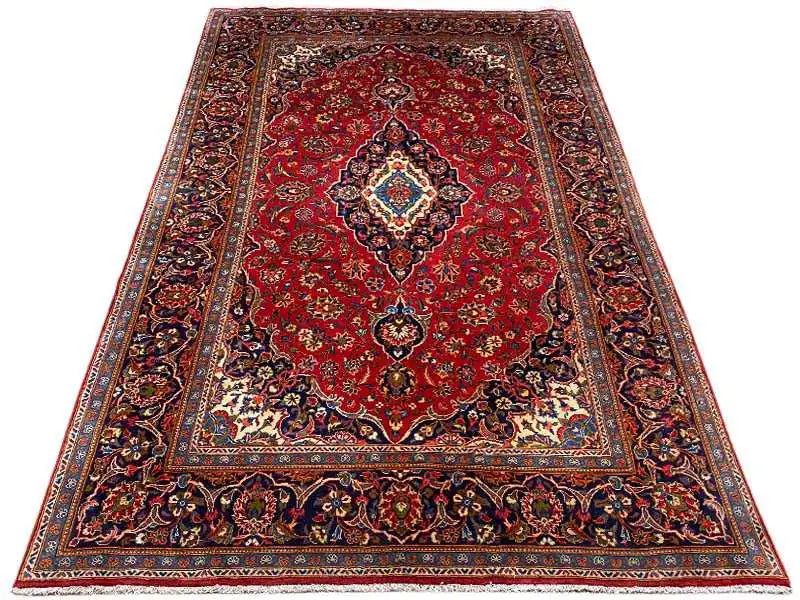 Red oriental rug with a central medallion and surrounding ornamental border