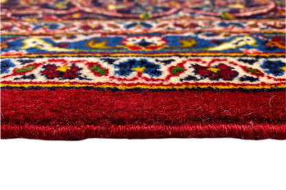 Carpet border with red pile, multicolored ornamental trim, and white edge