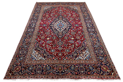 Red rug with a central ornament, dark border pattern, and blue accents