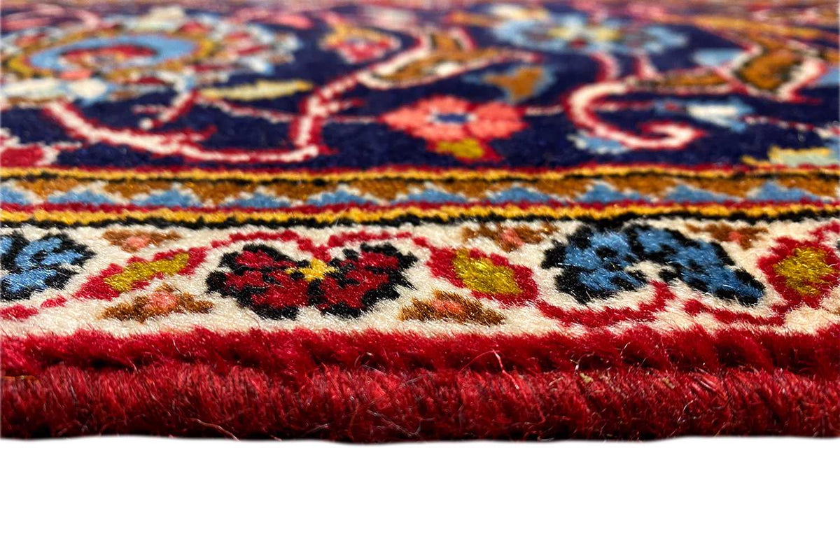 Carpet border in detail: colorful ornaments on a red background, with short pile