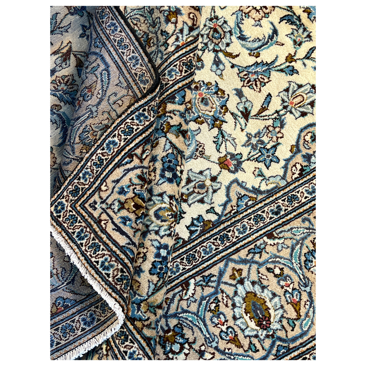 Ornamental rug with a floral pattern, cream-colored background, and blue borders