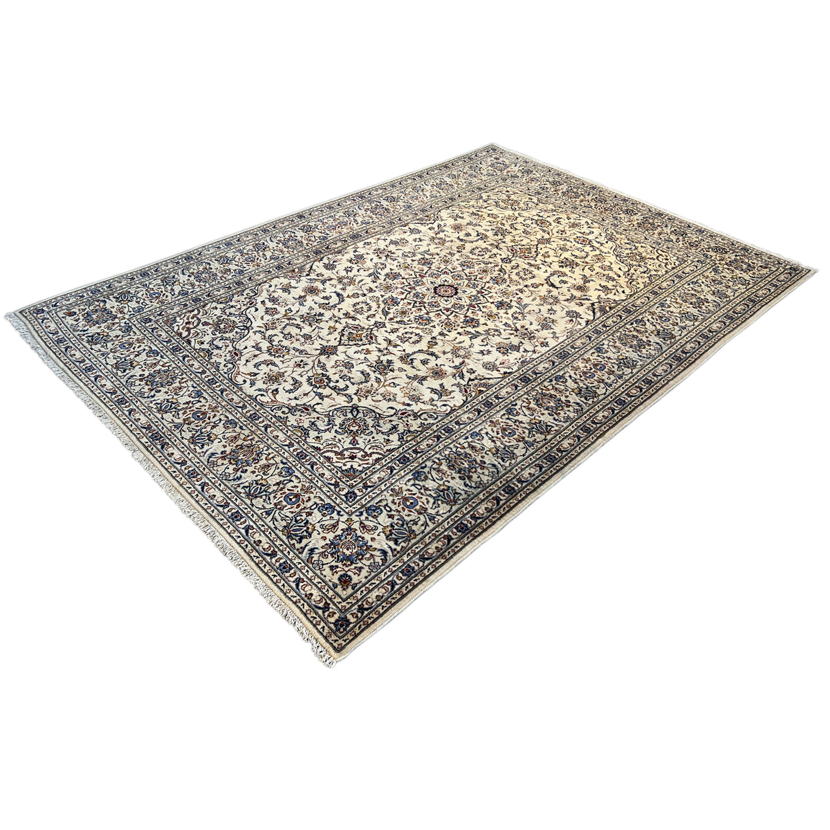 Keshan rug with a beige background and blue border ornament in three-quarter view