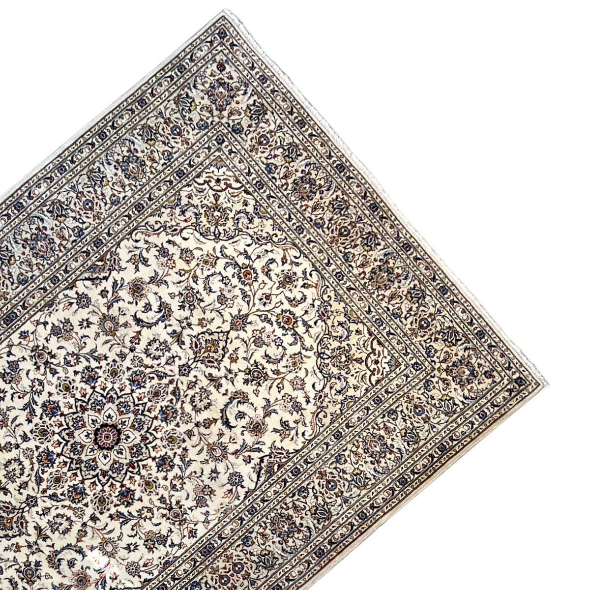 Keshan rug with a light medallion and blue line border viewed at an angle