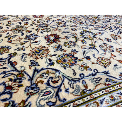 Close-up of the floral pattern: cream-colored background with blue, red, and golden accents