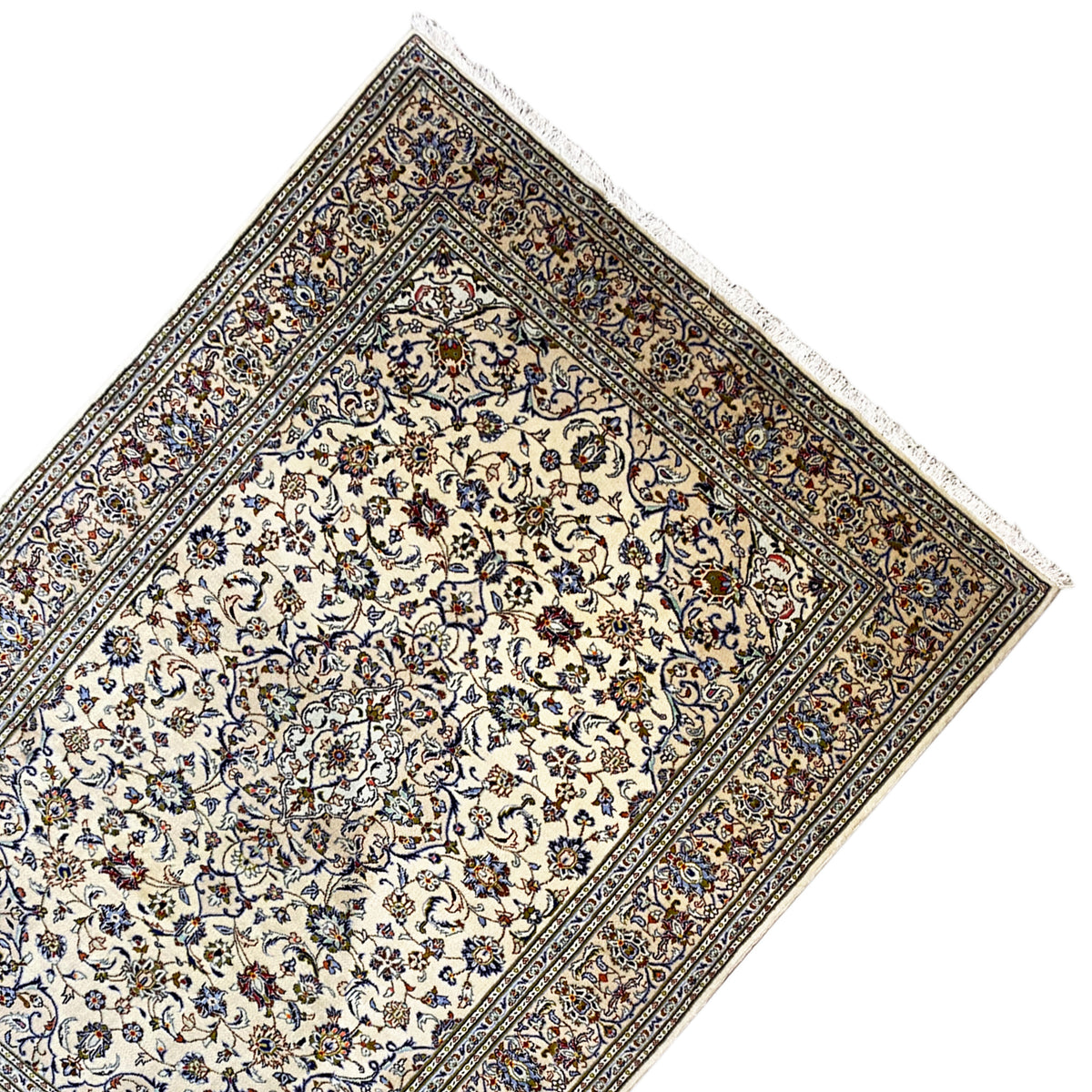 Keshan rug in an angled view with a cream-colored medallion field and ornamental border
