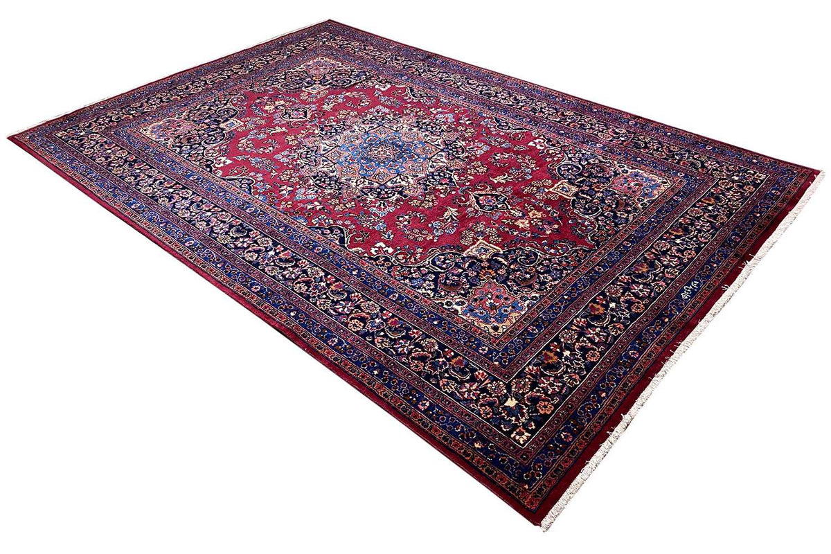 Oriental rug with a red center and dark blue ornamental border