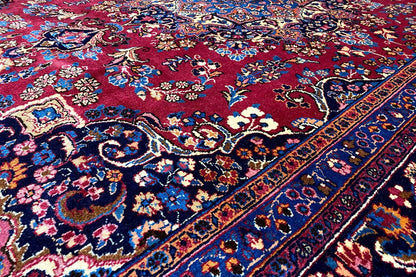 Close-up of an oriental rug: blue field, red medallion, and ornaments