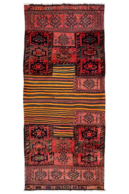 Rectangular kilim rug with central patchwork motifs in red and a yellow-striped central section