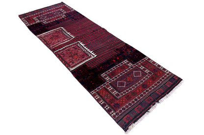 Bakhtiari kilim rug laid at an angle: geometric medallions, red and blue color blocks, fringes.