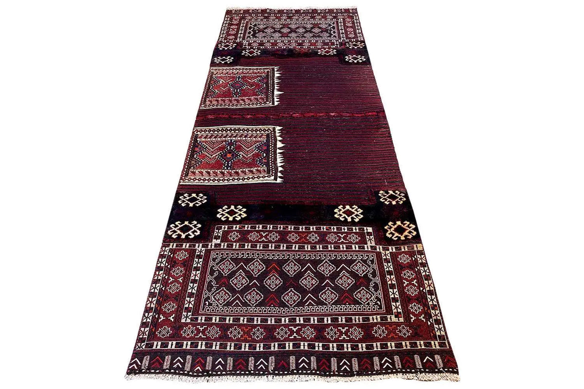 Kelim Bakhtiari rug: triangular overhead view with a framed border, burgundy and dark blue.