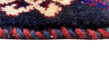 Bakhtiari kilim: dark pile, red threads, and a blue-and-white patterned border, with fringes