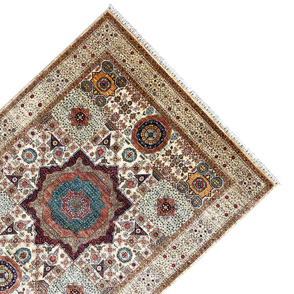Close-up: Beige wool rug with decorative border, colorful motifs, and fringes