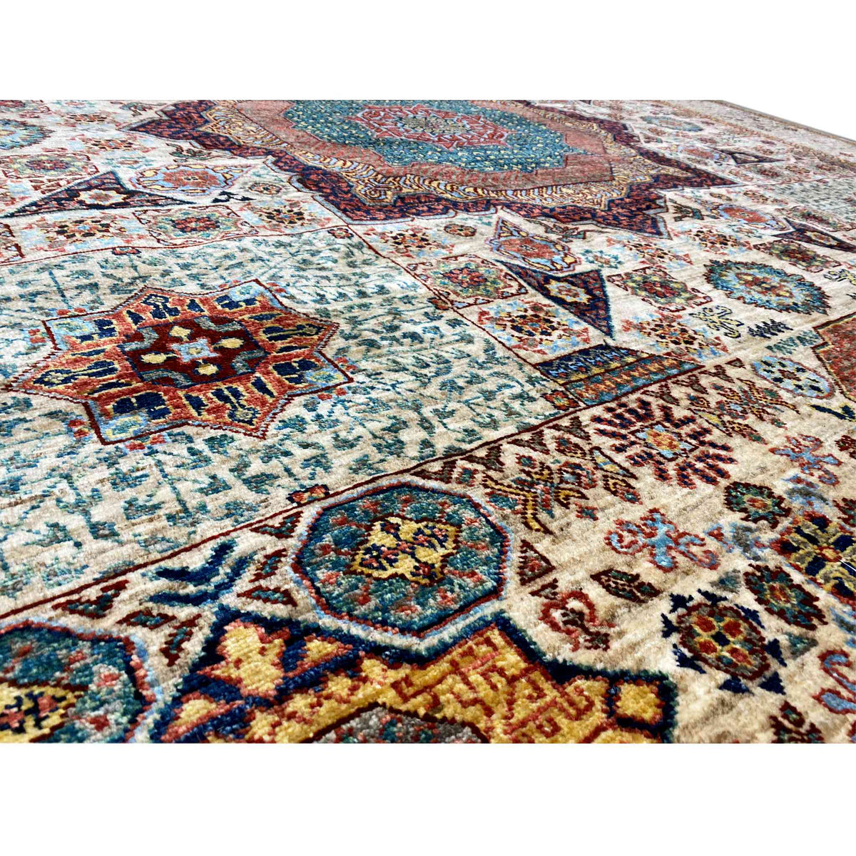 Close-up of the wool rug: dense pattern with colorful ornaments and visible pile texture