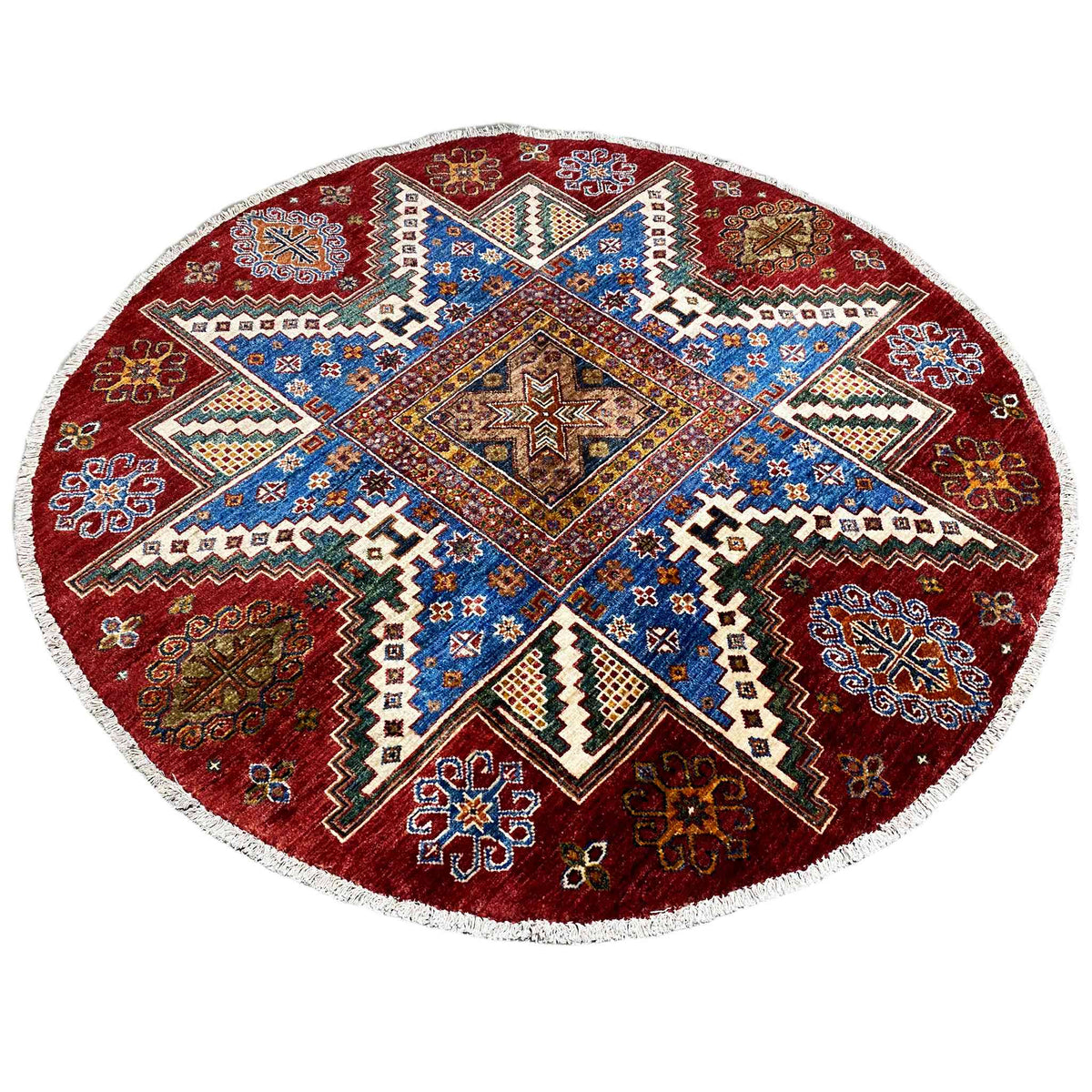 Round wool rug with a blue central star, reddish-brown ornamental border, and white edging