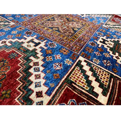 Detail view: blue, red, and cream-colored zigzag and cross pattern in the rug