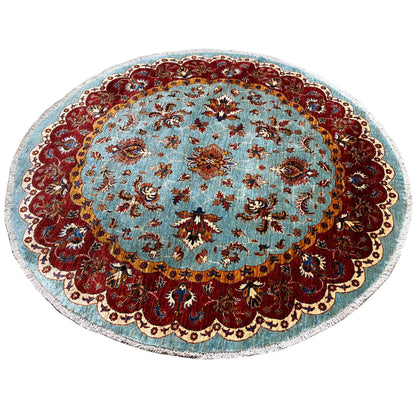 Round Khorjin rug: blue with delicate floral motifs and a red decorative border