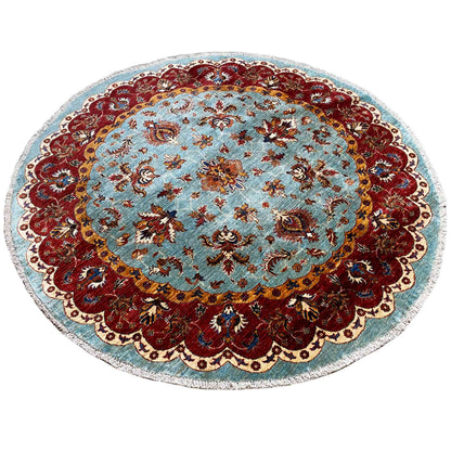 Round Khorjin rug: central floral ornament in blue and red with a scalloped edge