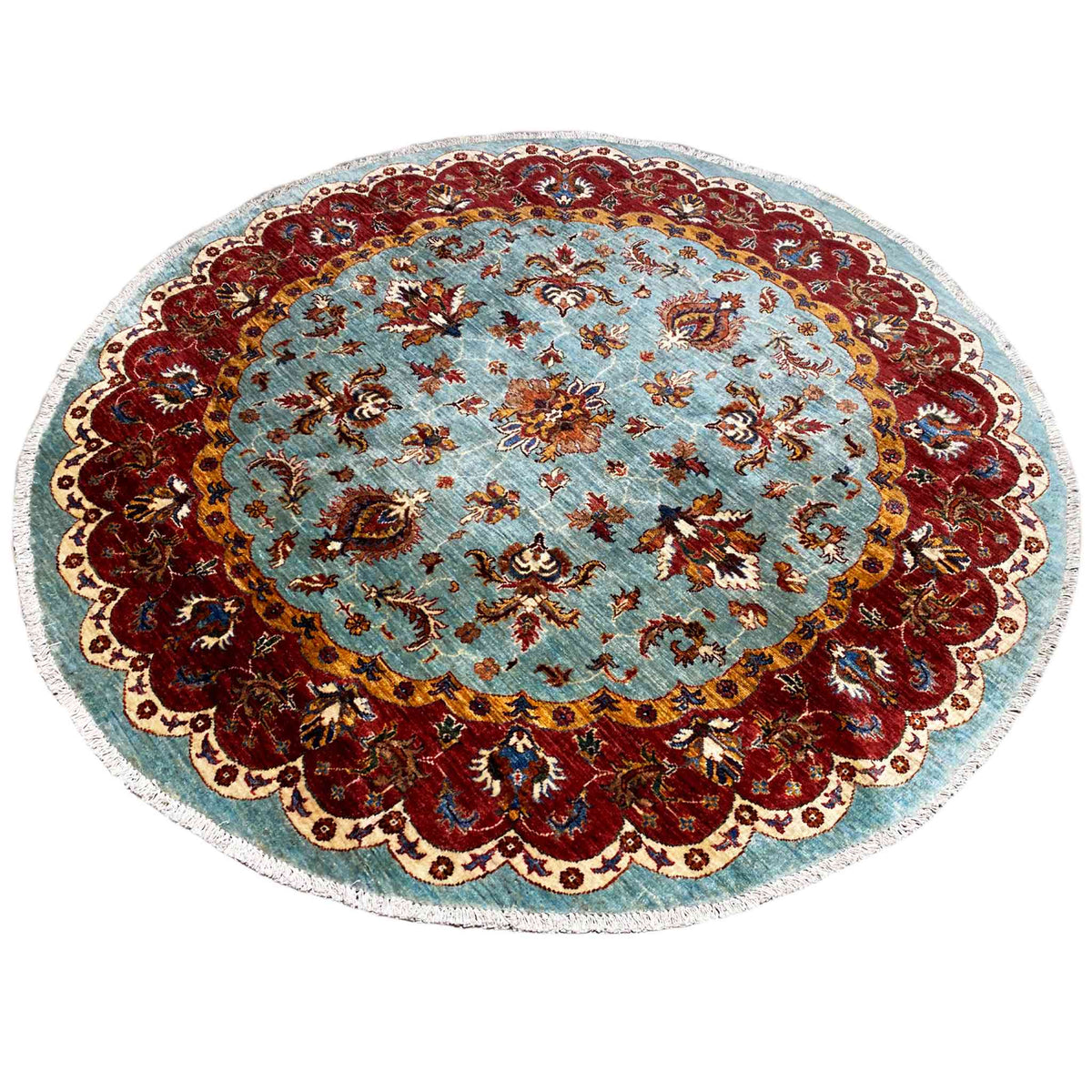 Round Khorjin rug: blue-red patterns, bold border with playful frame ornaments