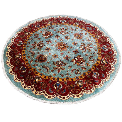 Round Khorjin rug: blue-red patterns, bold border with playful frame ornaments
