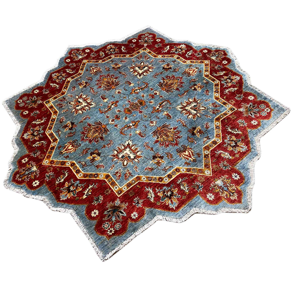 Star-shaped rug with a blue and red medallion and floral patterns