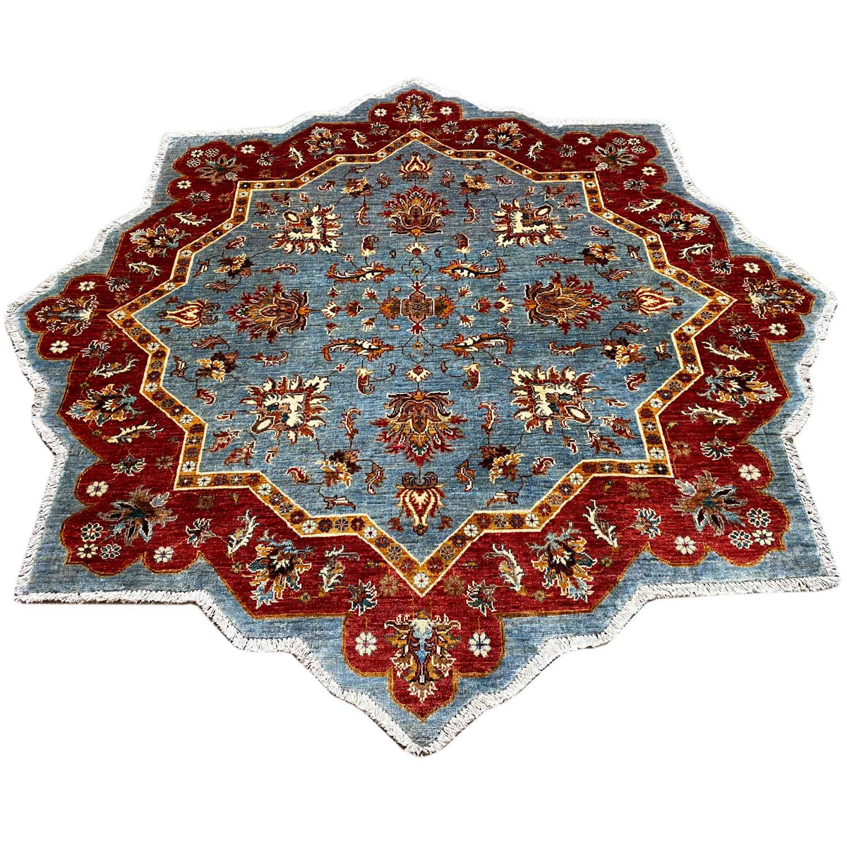 Star-shaped carpet with a blue central field, red border, and gold ornaments