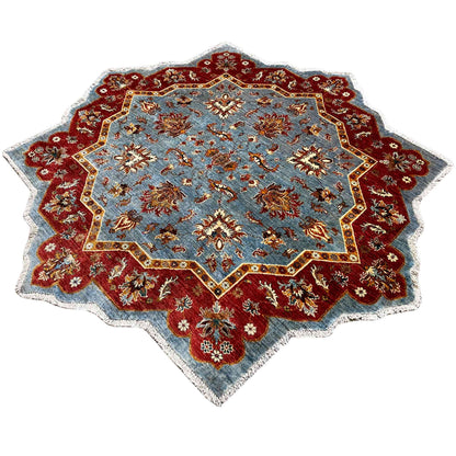 Star carpet with a blue inner field, red outer border, and ornate edging