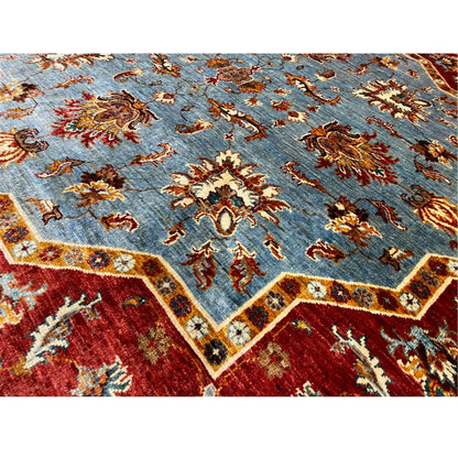 Close-up: blue carpet field with red-and-gold motifs and a fine woven texture