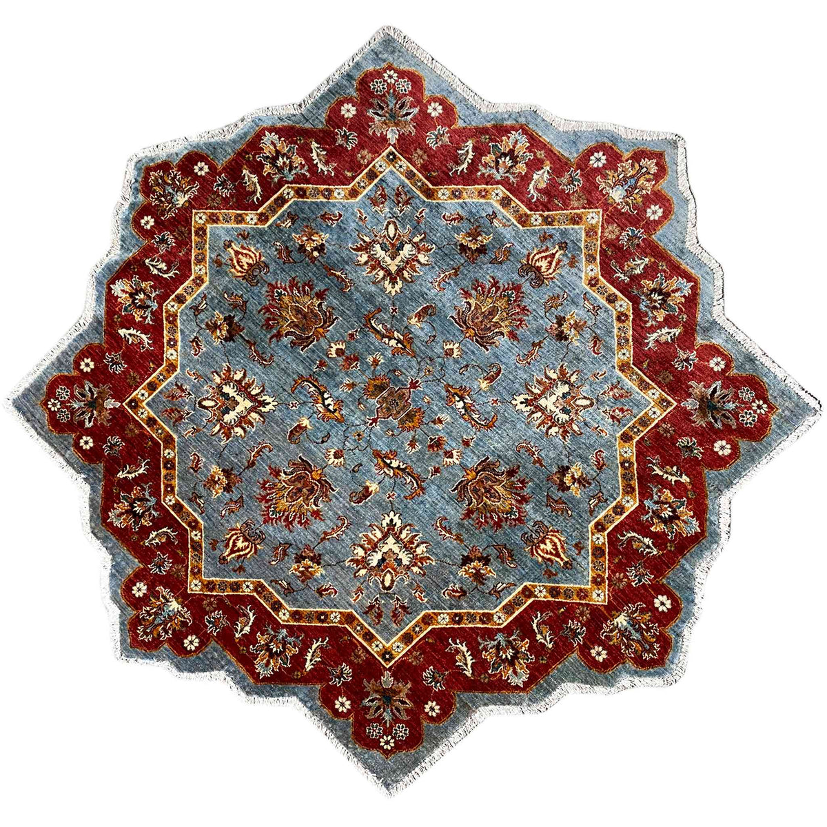 Star-shaped hand-knotted wool rug with a blue background and red ornamental border