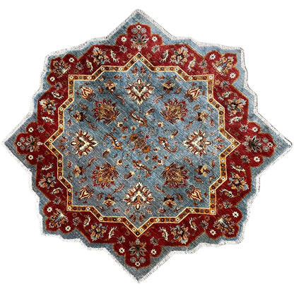 Star-shaped hand-knotted wool rug with a blue background and red ornamental border