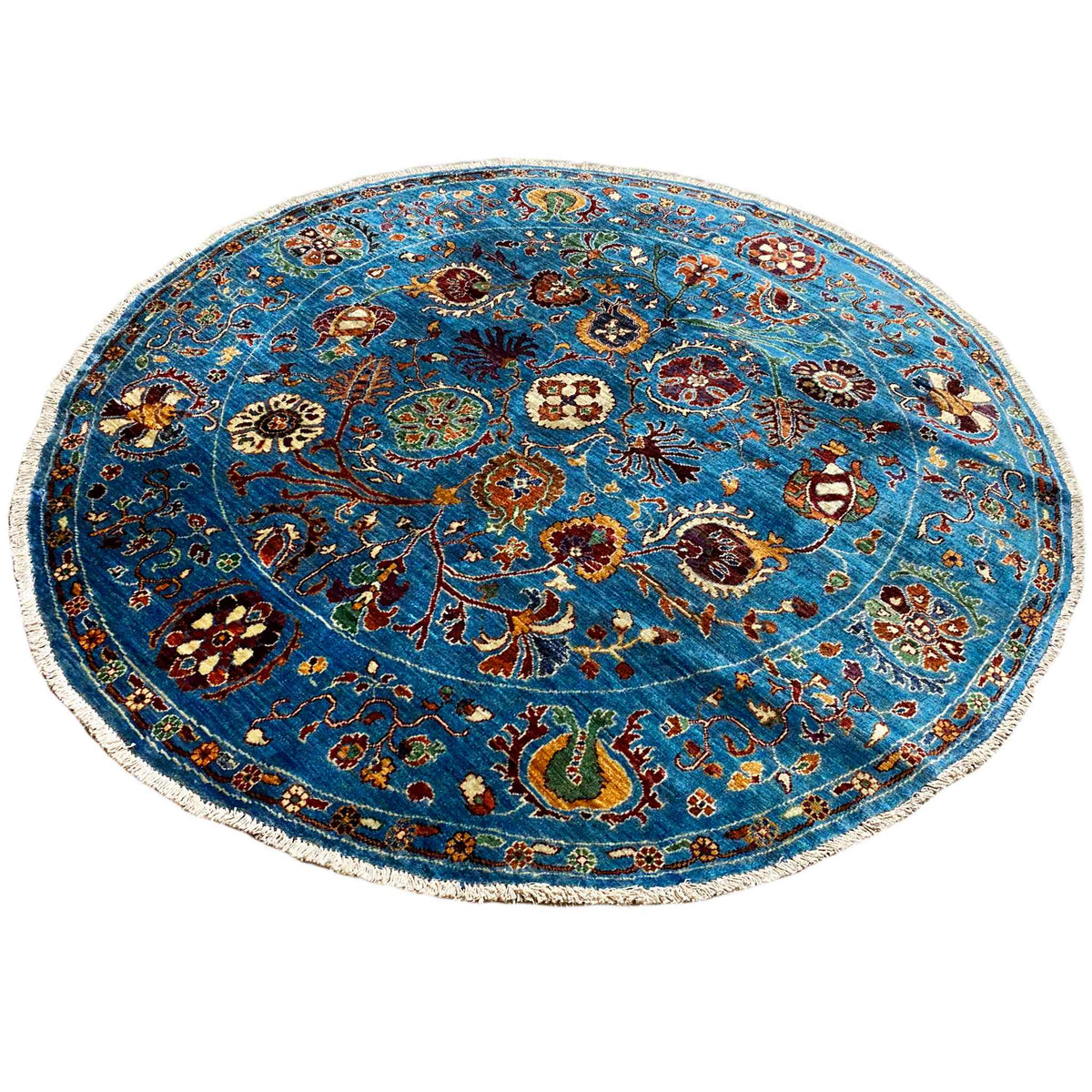 Round wool rug in blue with a symmetrical ornamental field and decorative border