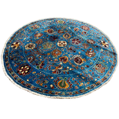 Round wool rug in blue with a symmetrical ornamental field and decorative border