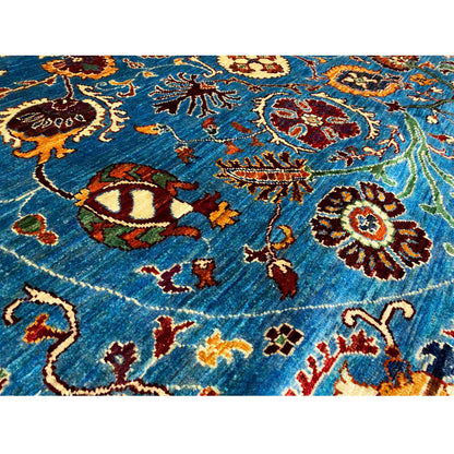Round rug fiber detail: blue wool fabric with multicolored embroidery