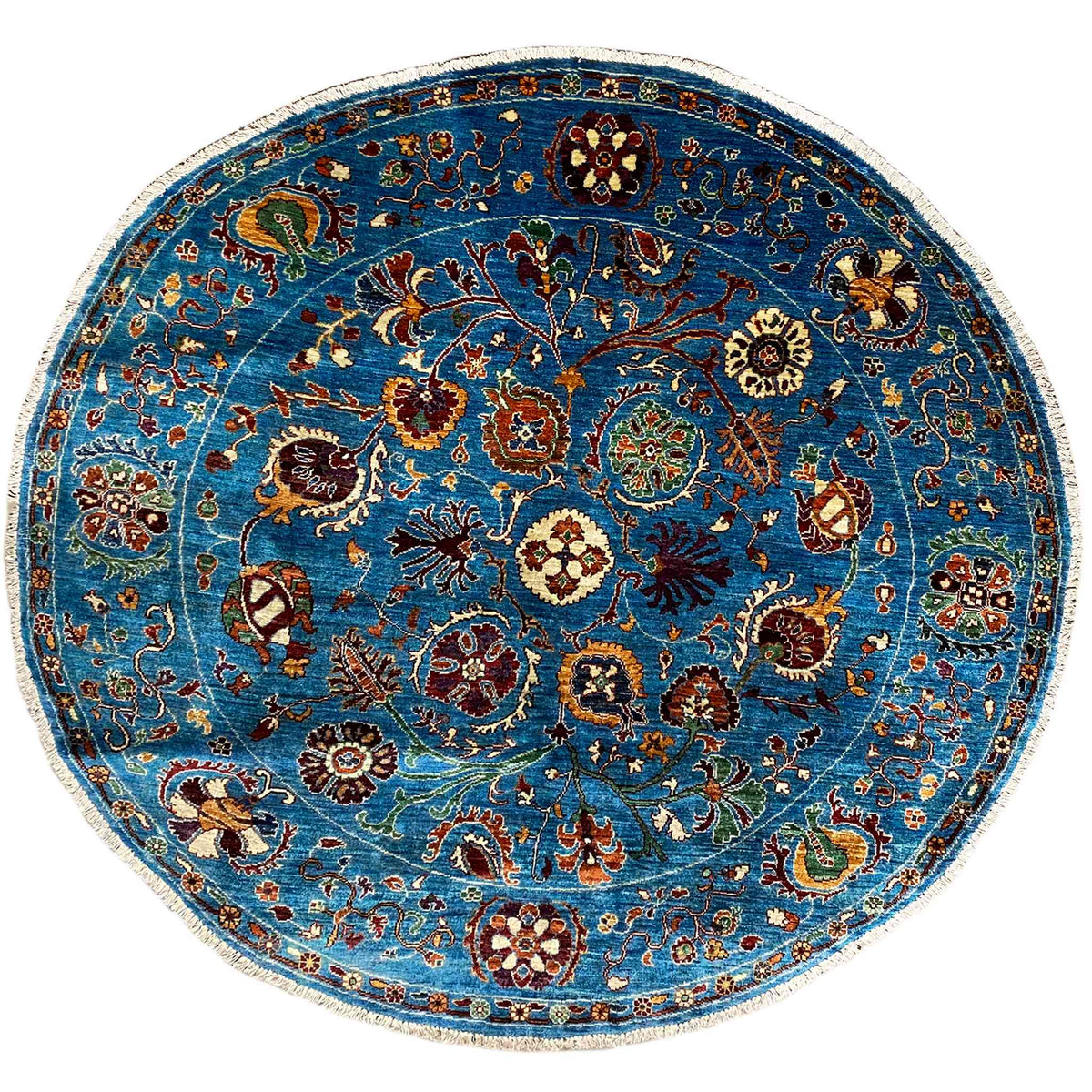 Round wool rug, blue, with a colorful ornamental pattern and a light contrasting border
