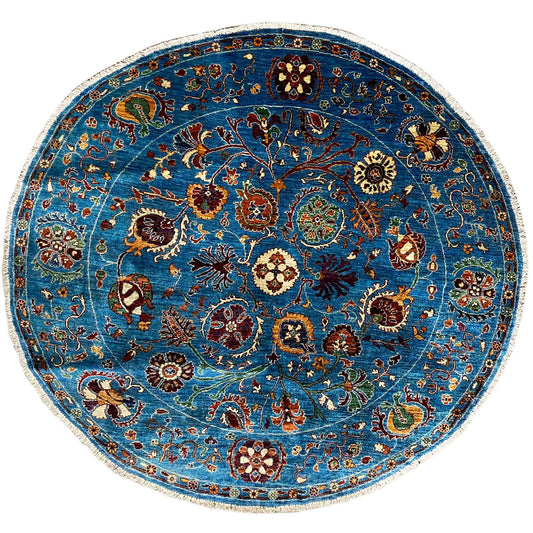 Round wool rug, blue, with a colorful ornamental pattern and a light contrasting border