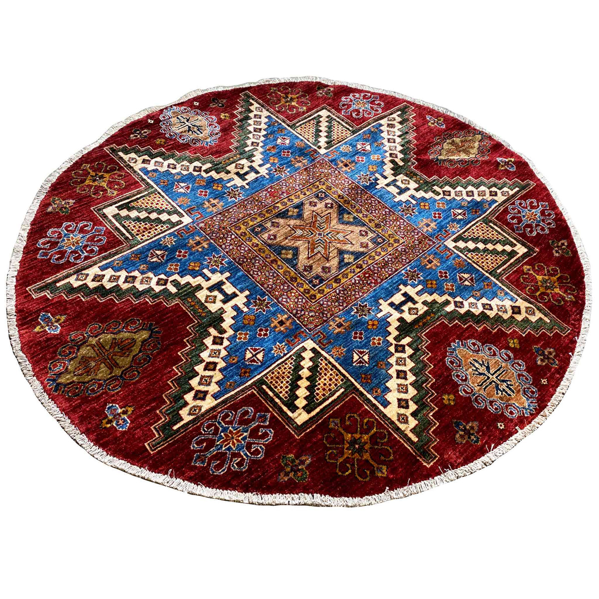 Round rug with a red background and blue central symbol in a patchwork ornament