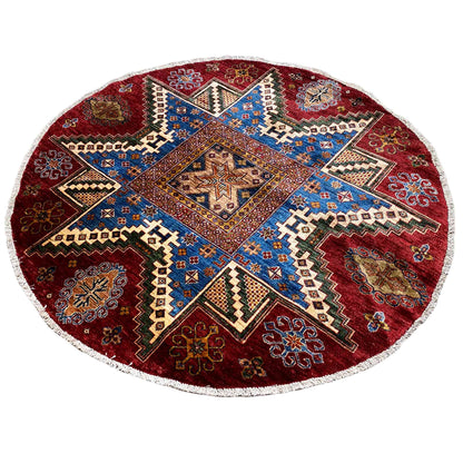 Round rug with a red background, blue central medallion, and geometric pattern