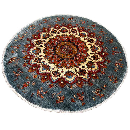 Circular Khorjin rug with a red central ornament on a blue-gray background