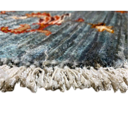 Rug border with white fringe trim on a blue-gray background