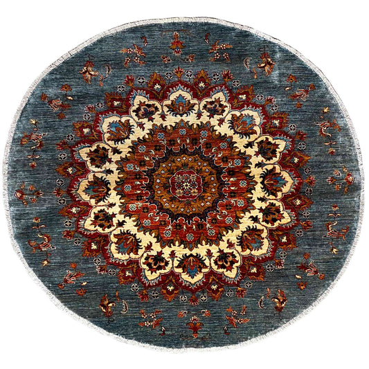 Round Khorjin rug with a medallion pattern in blue, red, and cream