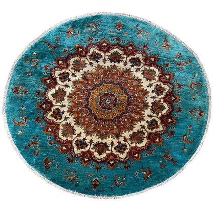 Round turquoise Khorjin rug with an ornate central medallion and multicolored pattern.